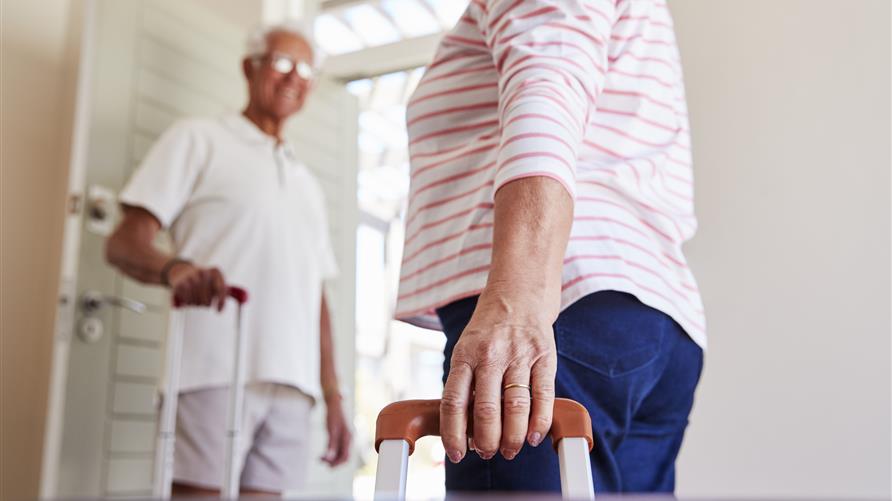 Mature couple walking out the door happy to go on vacation with Hilton Grand Vacations. 