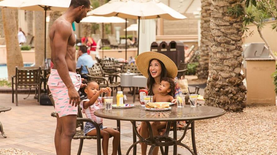 A family of color eating poolside at Hilton Grand Vacations Club on The Boulevard, Las Vegas, Nevada. 
