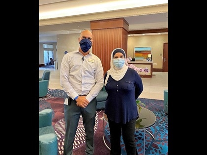 Hilton Grand Vacations Loss Prevention Director Ivan Melians and HGV Owner Mrs. Barakat. 