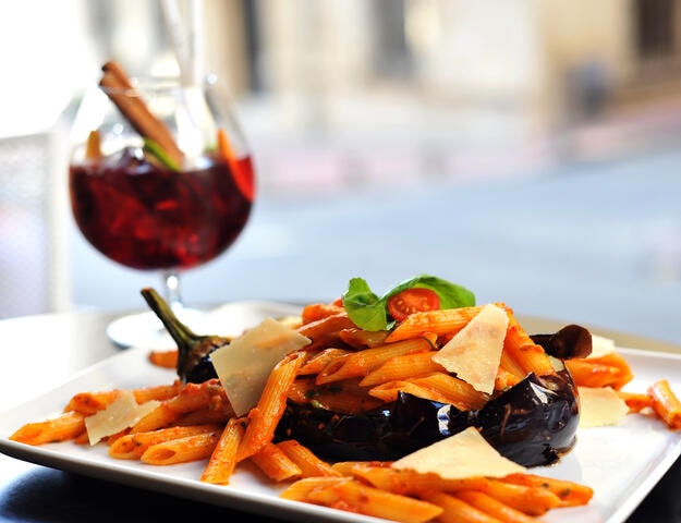 Beautifully plated food and a wine glass. 