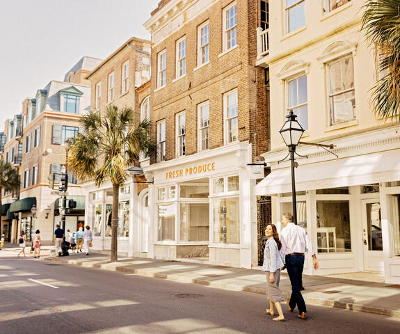 Couple walking hand in hand in Charleston, South Carolina. 