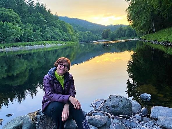 Hilton Grand Vacations Explorer posing by a creek in Dunkeld, Scotland. 