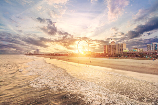 Aerial shot of shoreline, Boardwalk and Skywheel at sunset, Myrtle Beach, South Carolina. 