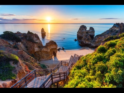 Picturesque wooden boardwalk leading to the beach in Portugal.