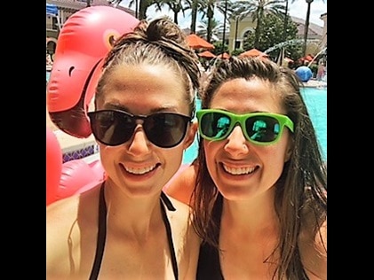 Hilton Grand Vacations Owner and sister snapping poolside vacation selfie.