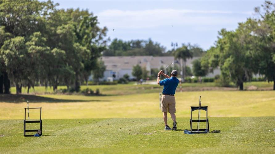 A golfer finishing a swing at the newly renovated Mystic Dunes Golf Course in Celebration, Florida, near Orlando