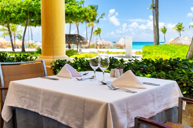 Beautifully set table overlooking a tropical setting.