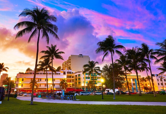 South Beach art deco buildings glowing colorfully against the dusk Florida sky, Miami, Florida. 