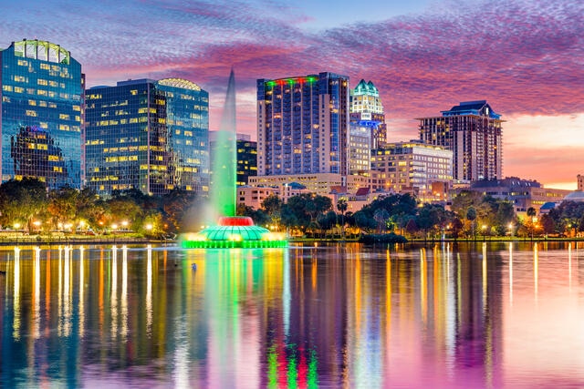 Lake Eola fountain and Orlando skyline beautifully aglow in the dusk sky, Florida. 
