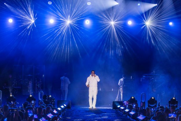 Hilton Grand Vacations Brand Ambassador, Boyz II Men, performing on stage. 