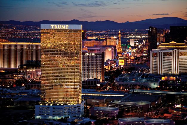 Las Vegas skyline glowing against dusk sky, mountains in distance, Nevada. 