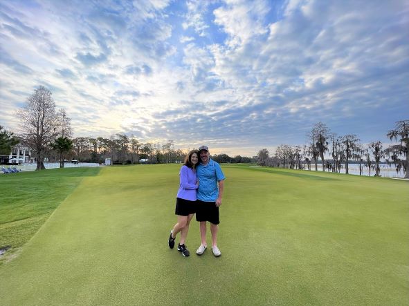 Hilton Grand Vacations Owners posing together, stunning backdrop, Hilton Grand Vacations Tournament of Champions, Lake Nona Golf & Country Club, Orlando.