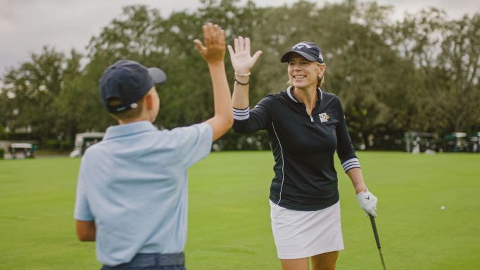 Annika Sorenstam, a Hilton Grand Vacations celebrity Brand Ambassador, high fives her son at the HGV Tournament of Champions