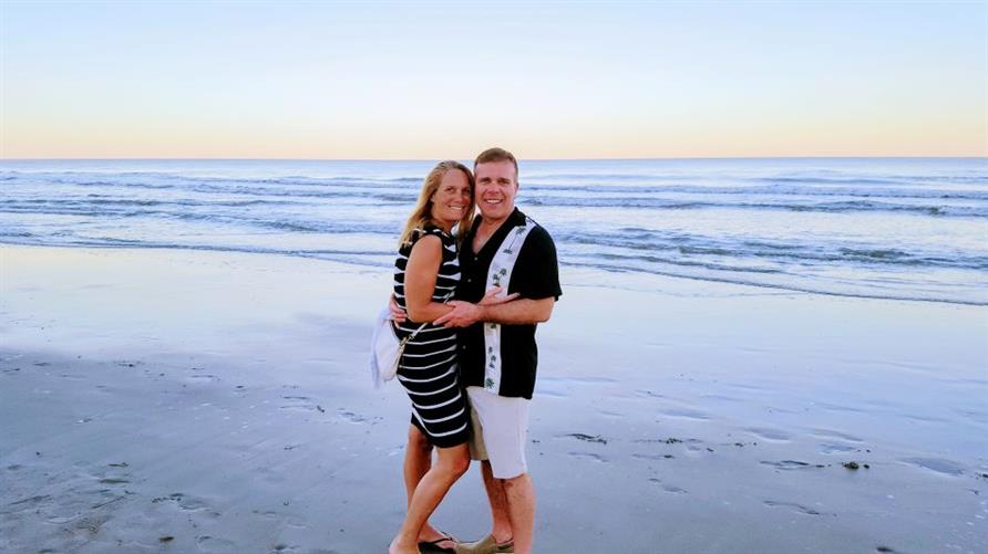 Two Hilton Grand Vacations Owners on the beach on vacation