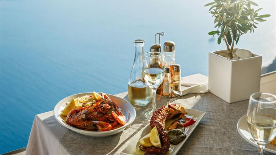 Dinner on white plates overlooking a body of water