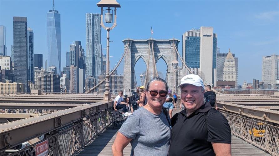 Two Hilton Grand Vacations Members on the Brooklyn Bridge on vacation in New York