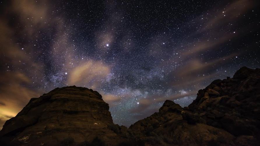 Starry skies above a wintery mountain