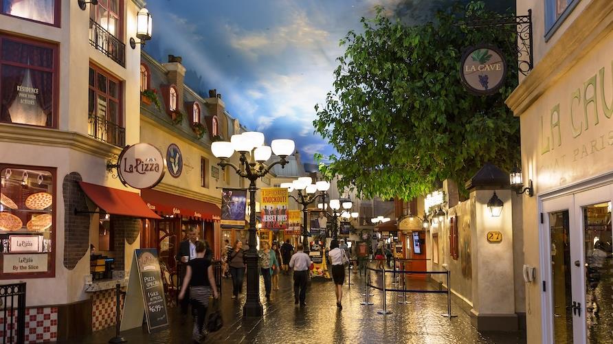 A replica of a themed shopping and dining area at Paris, Las Vegas. street of cafes and restaurants under old fashioned street lamps, and cobblestone
