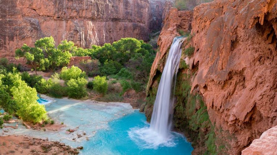 Beautiful turquoise waterfall, red rocks, American Canyonlands, Utah.