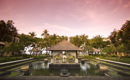 Serene poolside image, cabana with mosquito netting, Conrad Bali.