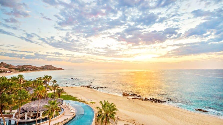Beautiful aerial coastal scene, golden sands, sunset skies, Los Cabos, Mexico. 