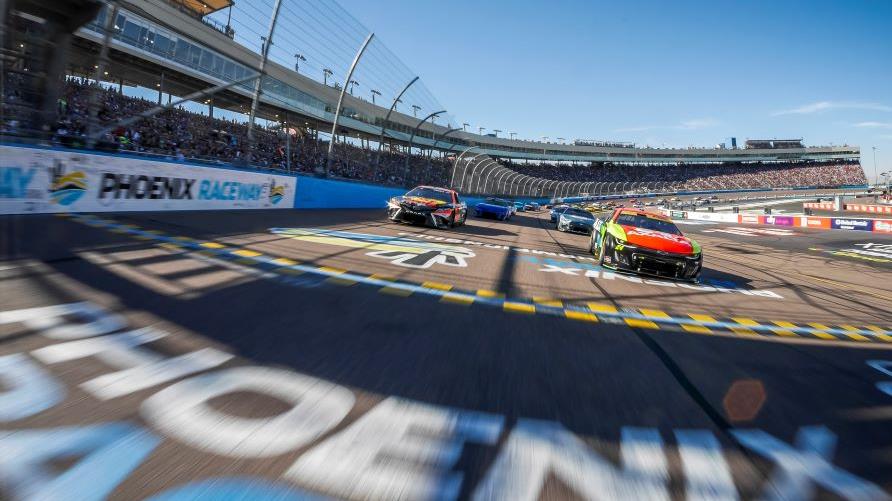 Stock racing cars crossing the finish line, NASCAR Cup Series Championship, Phoenix Raceway, Arizona. 