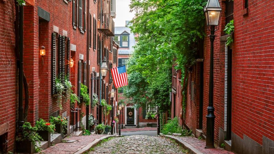 Cobblestone streets and red brick houses along Acorn Street in Boston, Massachusetts