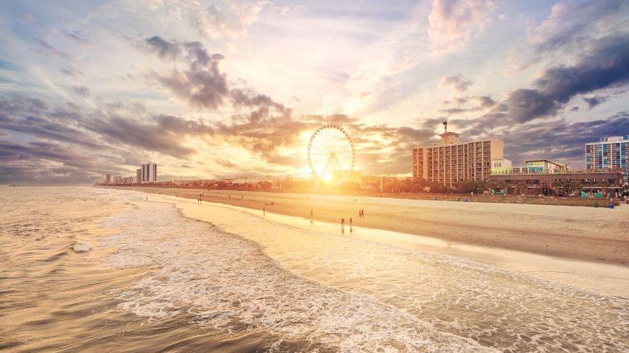 Gorgeous aerial image, sunset painted skies, Myrtle Beach Grand Strand, SkyWheel in the distance, South Carolina. 