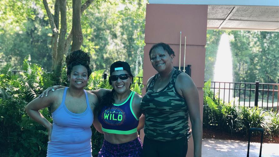 Hilton Grand Vacations Owner posing with friends after a workout at a Hilton Grand Vacations resort. 