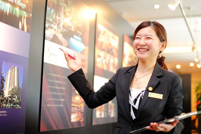 Smiling Hilton Grand Vacations Sales Executive during a timeshare sales presentation. 