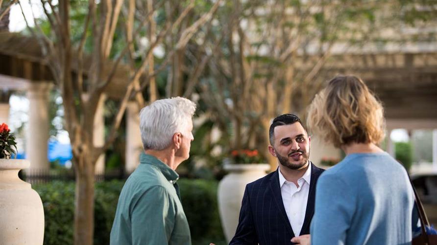 Hilton Grand Vacations team member speaking with Owners and Guests. 