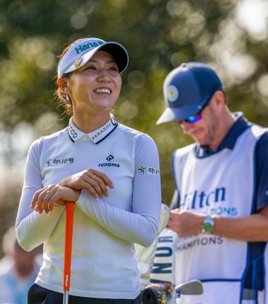 Woman golfer and a referee standing together