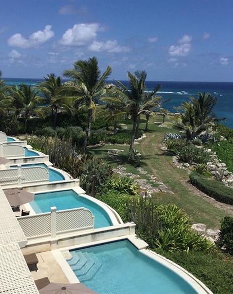 Pools overlooking the palm tree lined beach