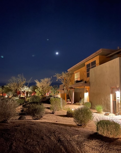 The moon sits above the illuminated Hilton Grand Vacations Club Palm Desert