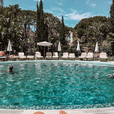 Blue pool with Portugal countryside in the background