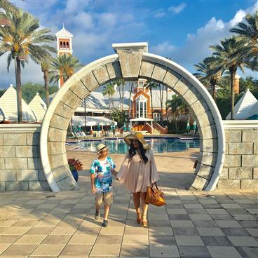 Couple walking through an archway.