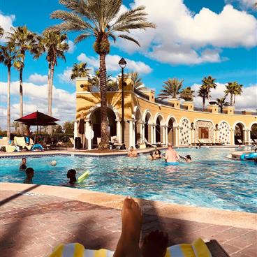 Sitting poolside at Tuscany Village.