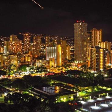 View of skyscrapers at Waikiki Beach at night.