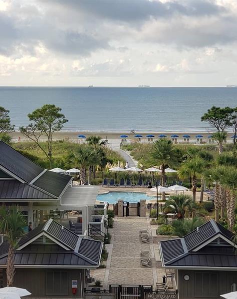 Overhead view of the Ocean Oak resort, courtyard and pool with the ocean in the background.