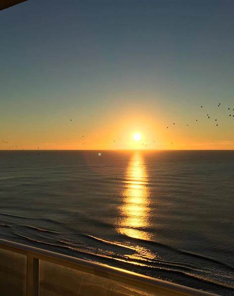 A colorful sunset over still water.