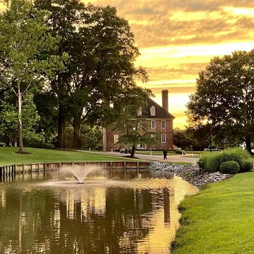 The sun sets over a scenic creek and The Historic Powhattan